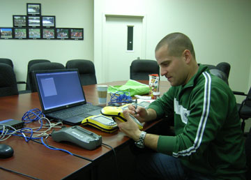 David Schmidt, a GIS Analyst at the CFIA, uploading data from global position system (GPS) handheld units used in a plum pox virus surveillance exercise in 2010