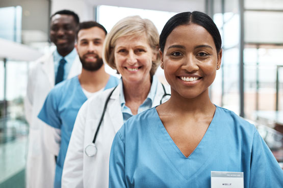 Four health professionals standing in a workplace
