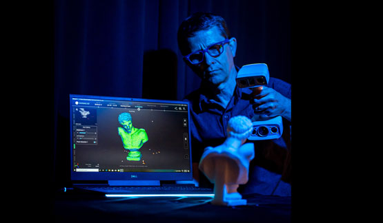 A man scanning a statue