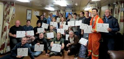 Captain Potts presents a happy group of greenhorns with their certificates