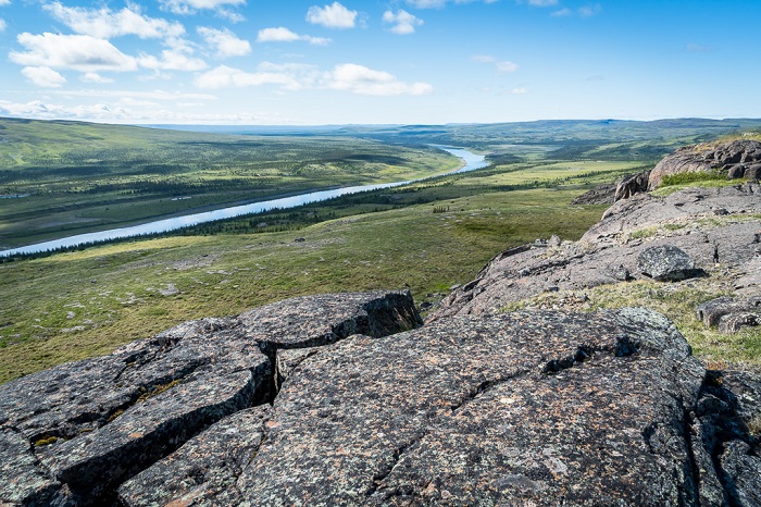 The Coppermine River snakes through a stunning landscape made up of volcanic rocks at the edge of the tree line