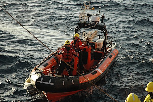 A rigid hull inflatable boat retrieves and tows the AUV back to the SWL.