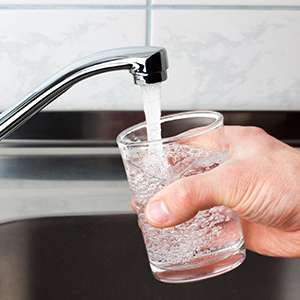 Why some communities adjust the level of fluoride in drinking water