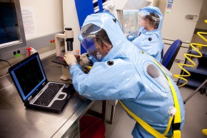 Two NML staff working in the level 4 lab