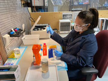 An employee with Dawnix Water Services, a Champagne and Aishihik First Nations citizen-owned business, tests wastewater in a laboratory located in the community. Photo credit: Champagne and Aishihik First Nations