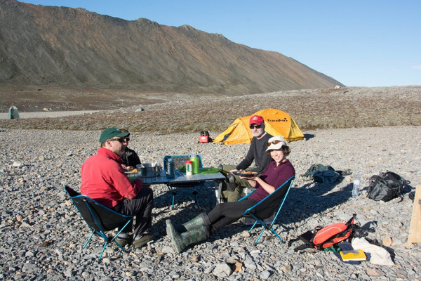In the summer, temperatures in the high Arctic can be warm and pleasant. Here is my team and I eating dinner and relaxing in the most beautiful dining room in the world, on Ellesmere Island.